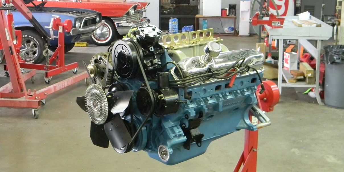 Rebuilt blue Pontiac 400 v-8 engine on a stand
